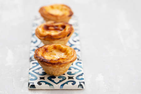 typical portugese egg tart pastel de nata on gray ceramic background