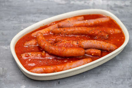 fresh sausages with tomato sauce on the dishの写真素材