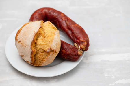 typical portuguese smoked sausage chourico with corn breadの写真素材