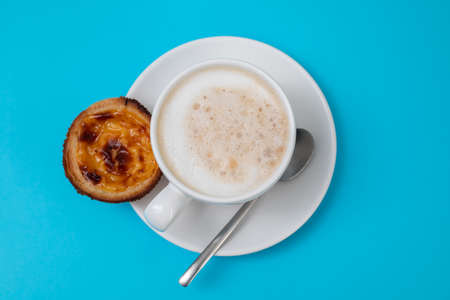typical portuguese dessert pastel de nata with cup of coffeeの写真素材