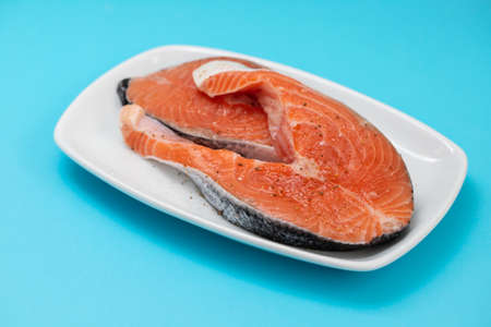 fresh raw salt with lemon on the dish on blue paperの写真素材