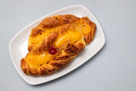 typical portuguese sweet bread with cream on the dish on grayの写真素材