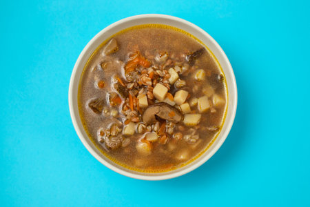 fresh mushrooms soup in small brown bowl on blueの写真素材