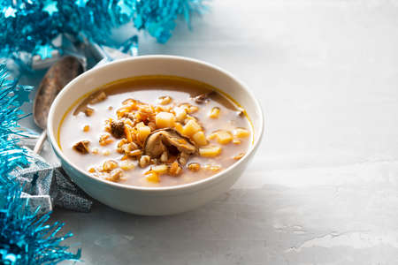 fresh mushrooms soup in small brown bowl on ceramicの写真素材