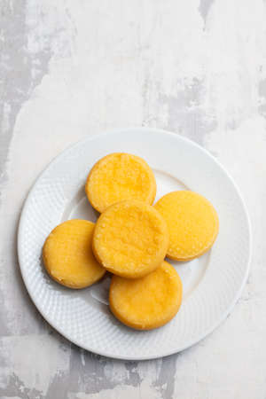 small puffed corn cakes on small white plate on ceramicの写真素材