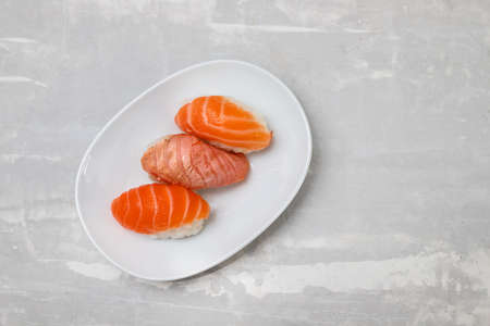 Assorted sushi on small white dish on ceramic top viewの写真素材