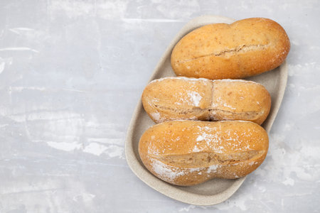few fresh bread in small dish on yellow paper