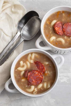 typical portuguese soup with smoked sausages and meat in bowlの写真素材