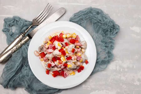 salad beans, corn and red pepper with sauce on white plateの写真素材
