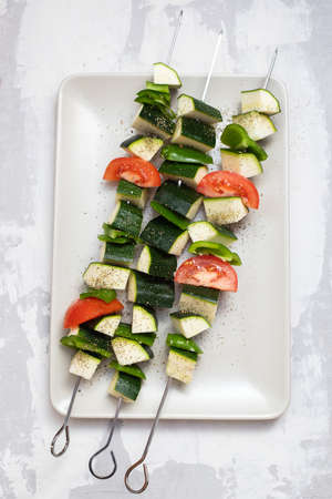 fresh uncooked vegetables in stick for grillの写真素材
