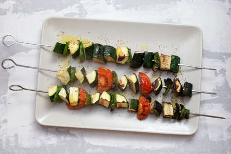 fresh grilled vegetables in stick on big gray dishの写真素材