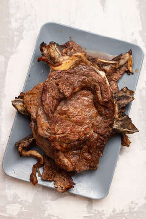 grilled fresh meat on big gray dish on ceramicの写真素材