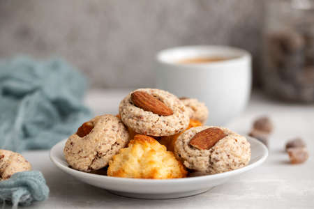 coconut and almond cookies on a small saucer on gray ceramic