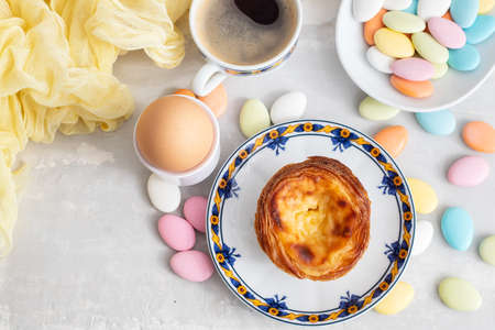 typical portuguese dessert pastel de nata and cup of coffee on ceramic