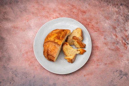 typical portuguese corn bread on gray plate on brown