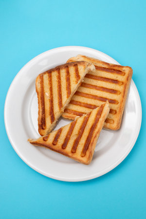 fresh breakfast toasts on white plate on blueの写真素材