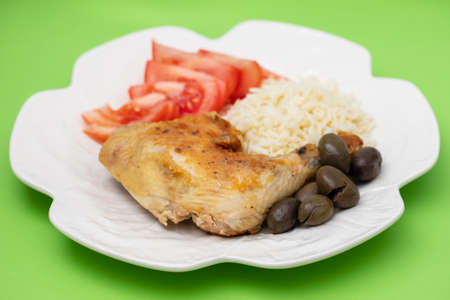 grilled chicken with boiled rice and fresh salad on white dish