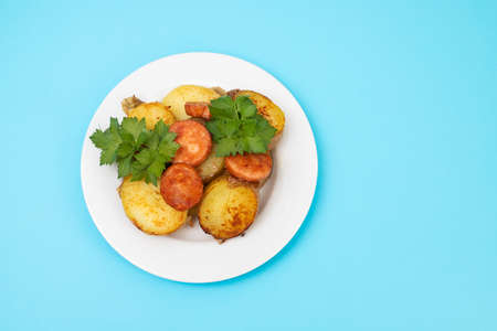 salad fried potato and smoked sausages on plateの写真素材