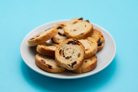 Mini round toasts of bread with raisins on dishの写真素材