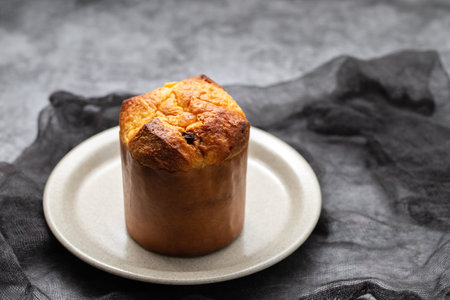 Delicious Panettone slice with sweet fruits on small dish