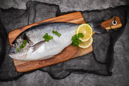 Closeup of fresh cooled whole raw bream on darkの写真素材