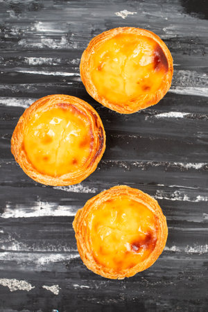 Egg tart, traditional Portuguese dessert, pastel de nata on darkの写真素材