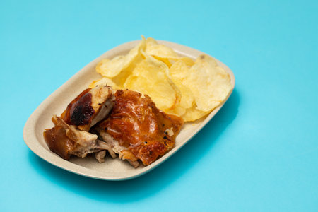 crispy tasty baked piglet and potato in ceramic dish