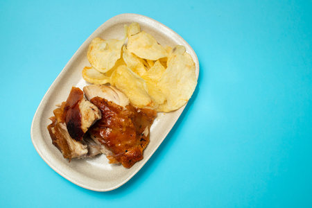 crispy tasty baked piglet and potato in ceramic dishの写真素材