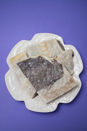 dry cod fish on white beautiful white big dish