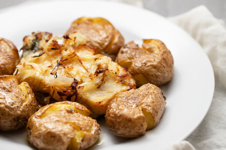 Traditional portuguese cousine, cod fish with potatoes and onions, covered with oil.の写真素材