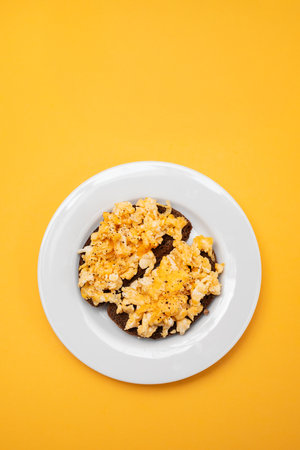 scramble eggs with black bread on dish
