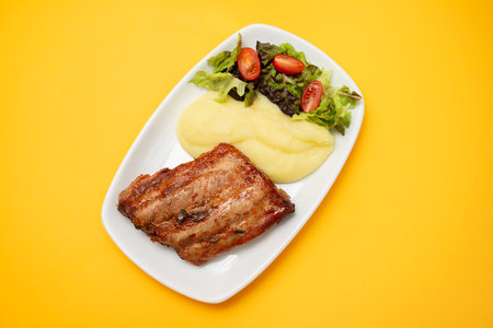 Fried Liver with boiled potato on plateの写真素材