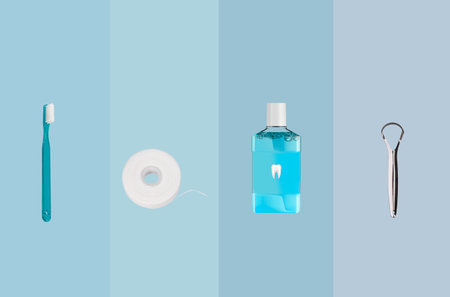 Toothbrush, dental floss and toothpaste on blue background. Oral Instrumentsの写真素材
