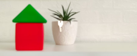 Blurred image of house and plant in pot on white table, non focusの写真素材