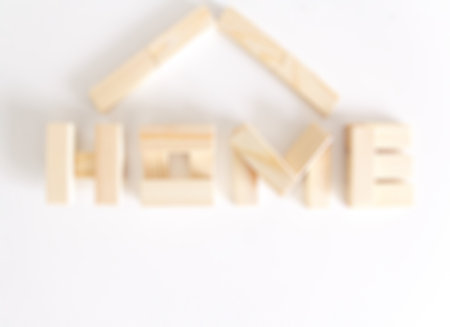Blurred background image of wood block in shape of house with space for text.の写真素材