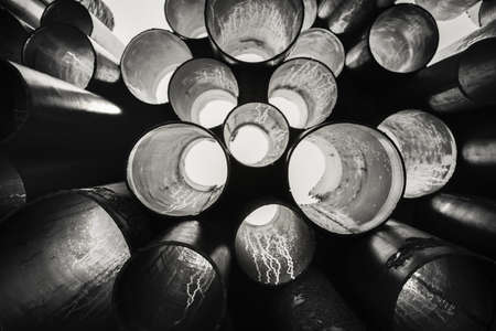 Steel pipes background & texture, through which the light is visibleの写真素材