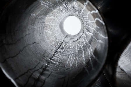 Steel pipes background & texture, through which the light is visibleの写真素材