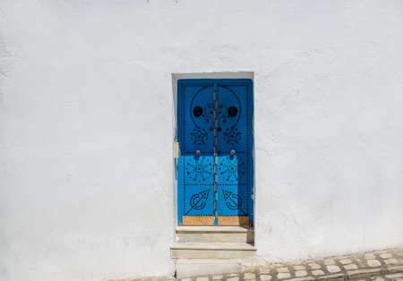Houses and streets of the magical white city. ancient blue door in oriental style.Sidi Bou Said. Tunisia.の写真素材