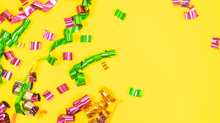 Festive yellow background with serpentine and copy space