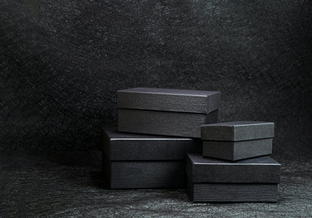 Four Black boxes gifts on black backgroundの写真素材