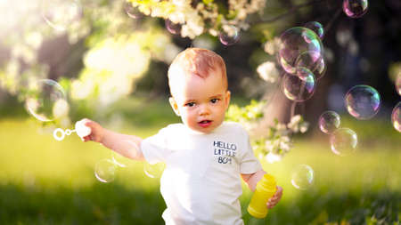 Portrait of a Little Boy Blowing Bubbles on the Streets