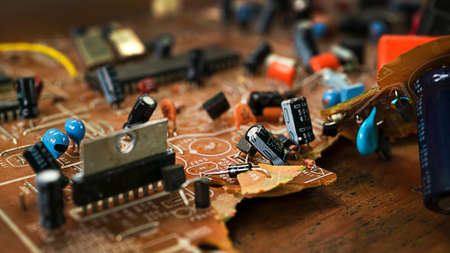 Old broken brown microcircuit close-up, old technologyの写真素材