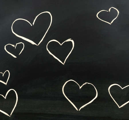 Hearts drawn in chalk on a blackboardの写真素材