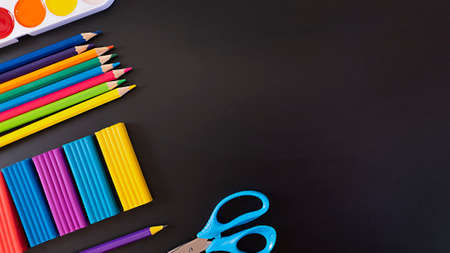 Concept back to school, school supplies on black chalkboard, top view with copy spaceの写真素材