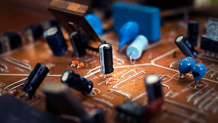 Old broken brown microcircuit close-up, old technologyの写真素材