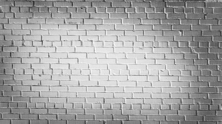 Old brick wall of grey blocks with wide cracks between themの写真素材