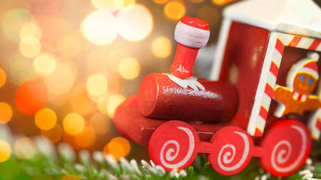Christmas photo card with toy Train close-up and bokeh. Christmas card, congratulation, holiday packageの写真素材