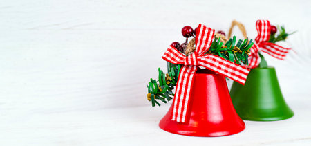 Christmas bells on white wooden background with copy spaceの写真素材