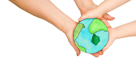 The human hands of a grandmother and a child hold a drawing of the planet Earth in their hands, the concept of preserving the earth for generations, caring for natureの写真素材