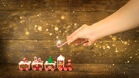 Brown rich wooden background from horizontal planks.Christmas toy train on a brown wooden background. Christmas card, congratulation, holiday package.の写真素材